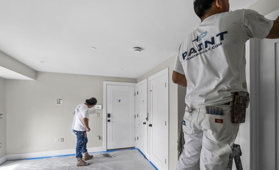 PAINT crew painting an interior hallway